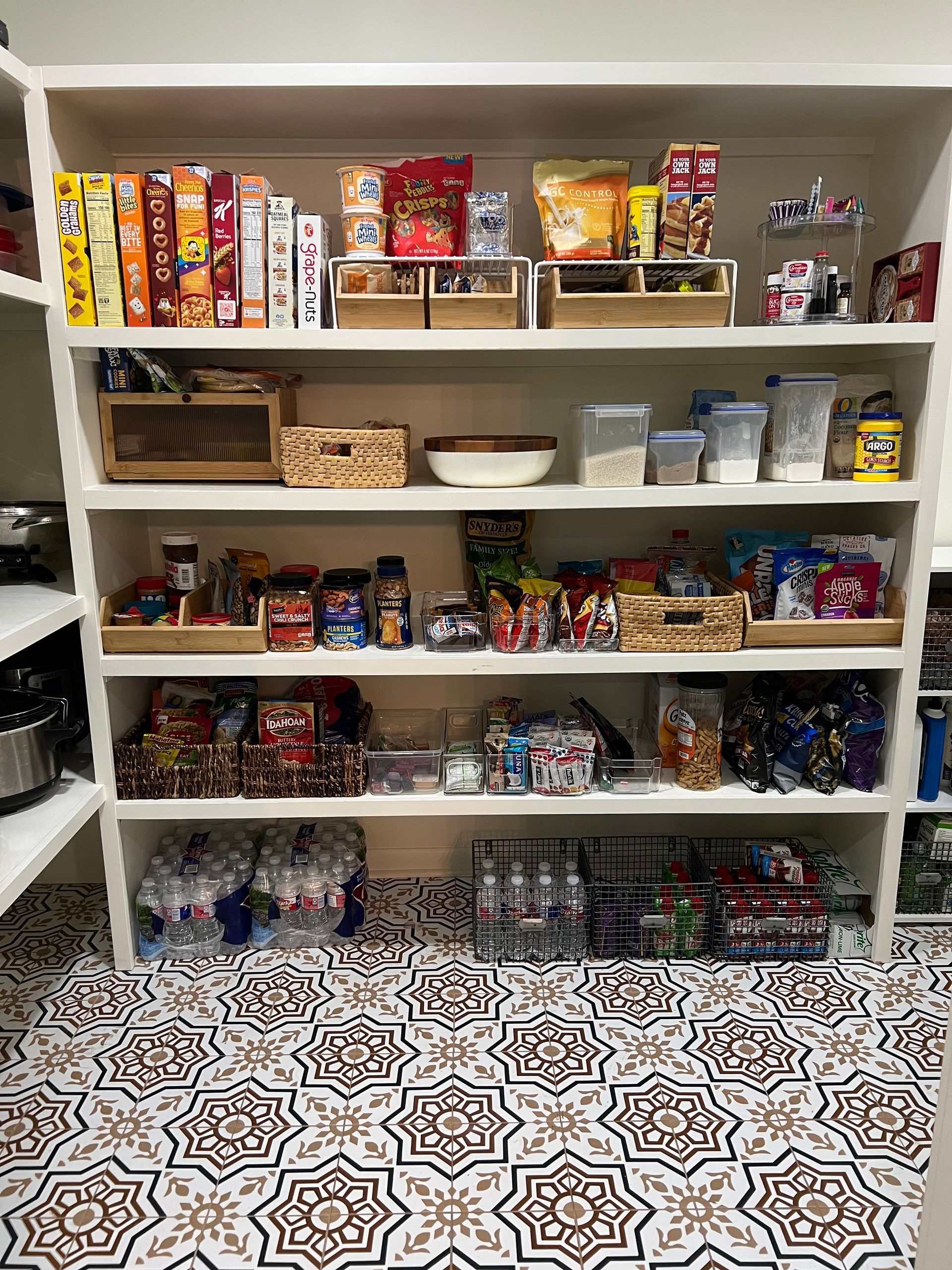 A pantry filled with lots of food and a tiled floor.