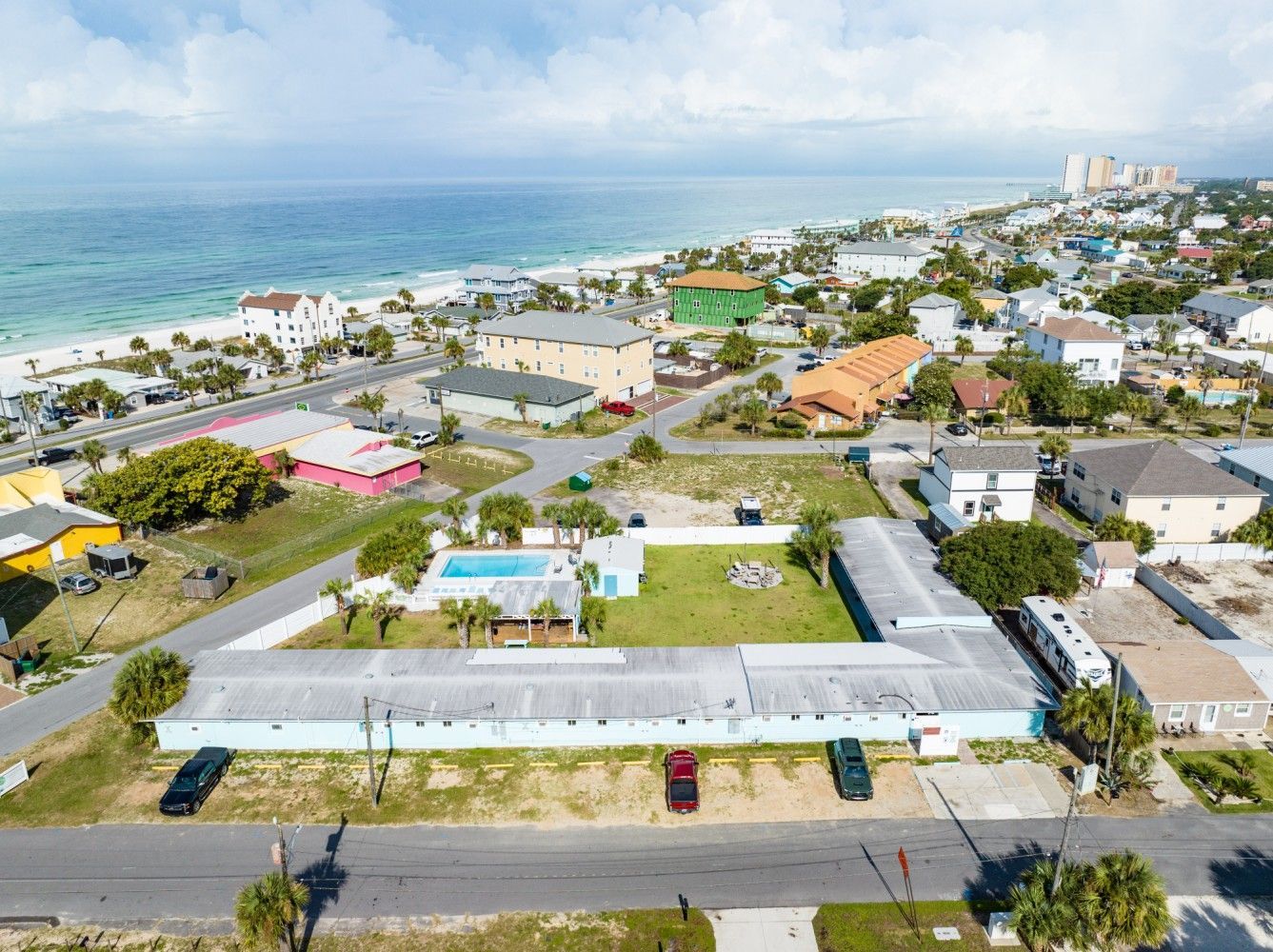 an aerial view of a large building next to the ocean .