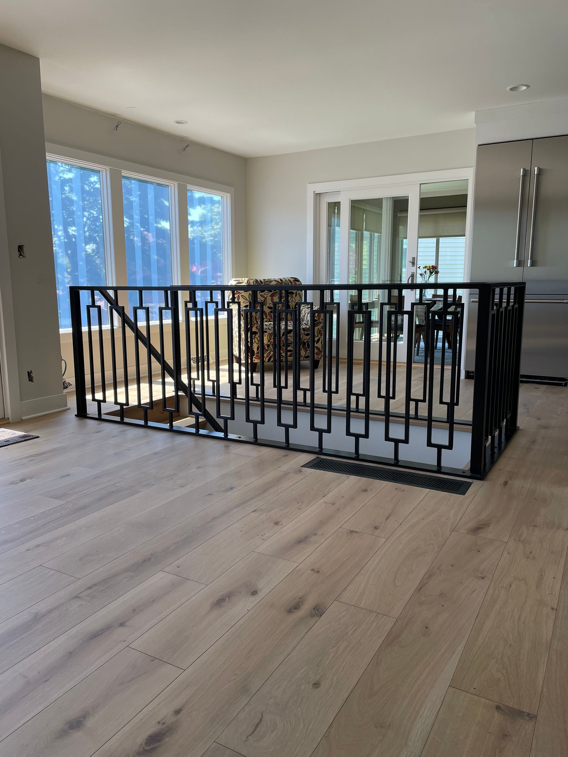 A staircase with a wrought iron railing in a living room