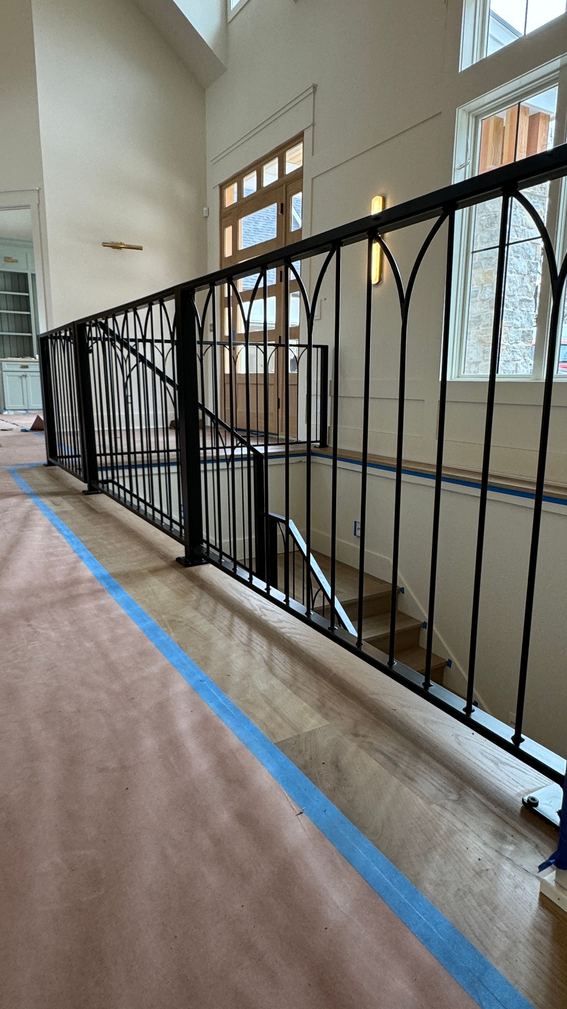 A wrought iron railing on a staircase in a house.