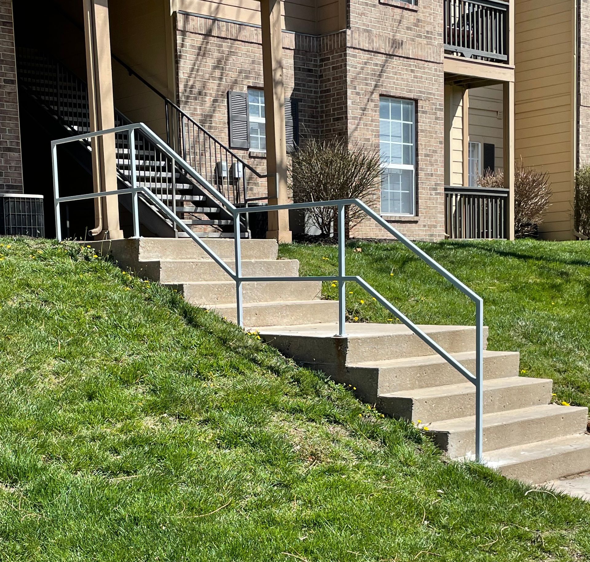 Stairs leading up to a building with a metal railing