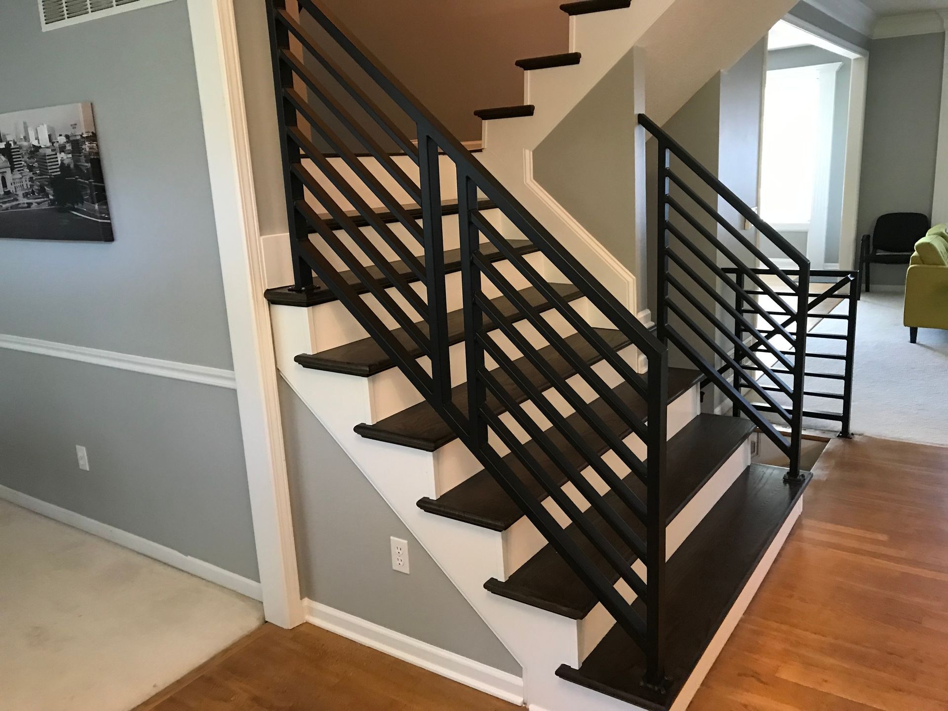 A staircase with a black railing in a house