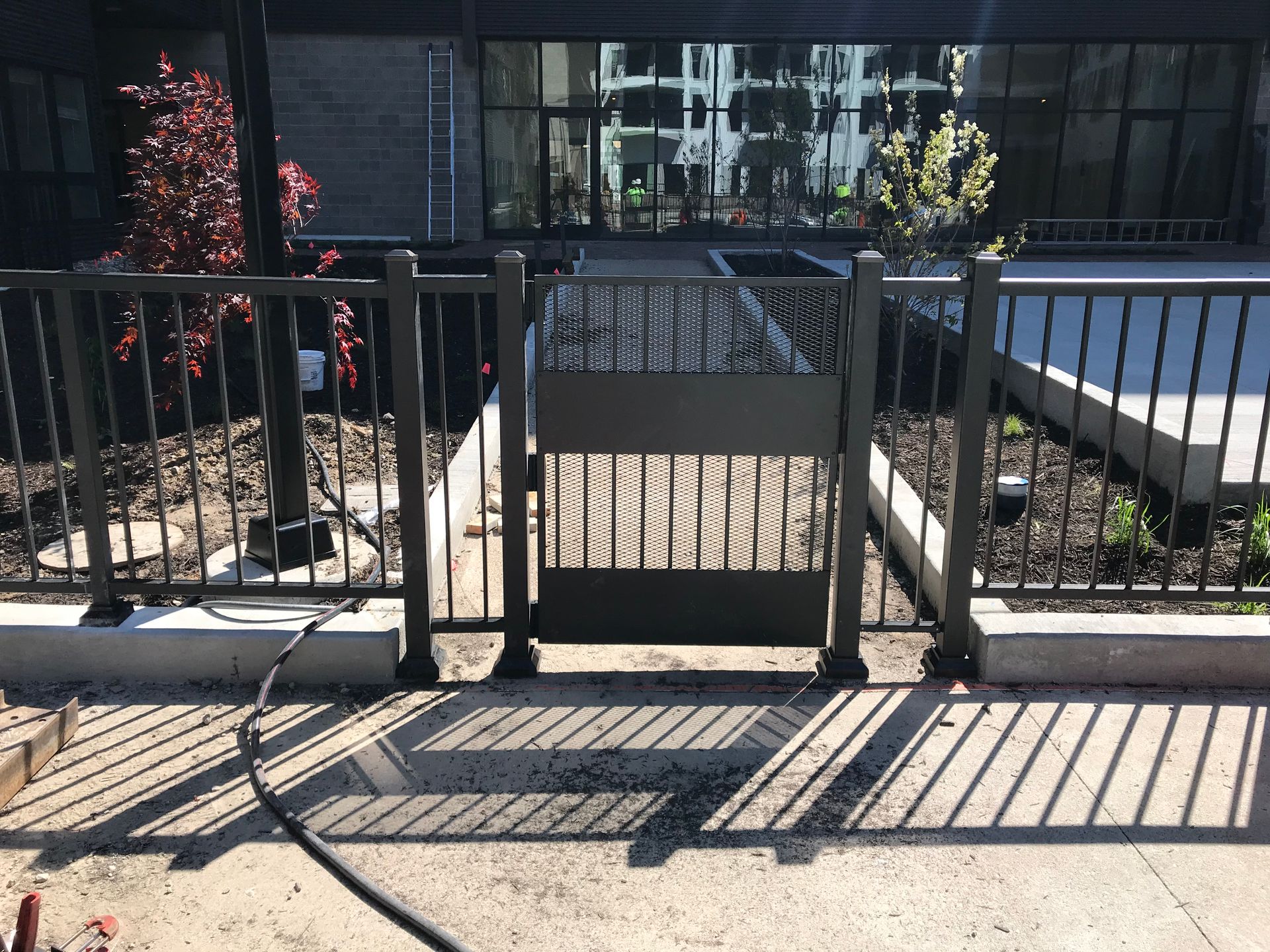 A fence with a gate in front of a building