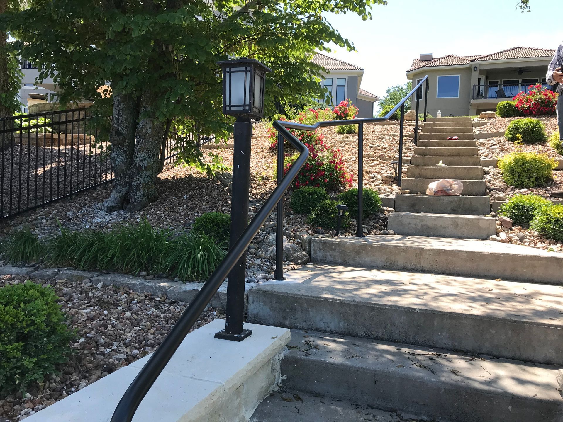 Stairs leading up to a house with a black railing
