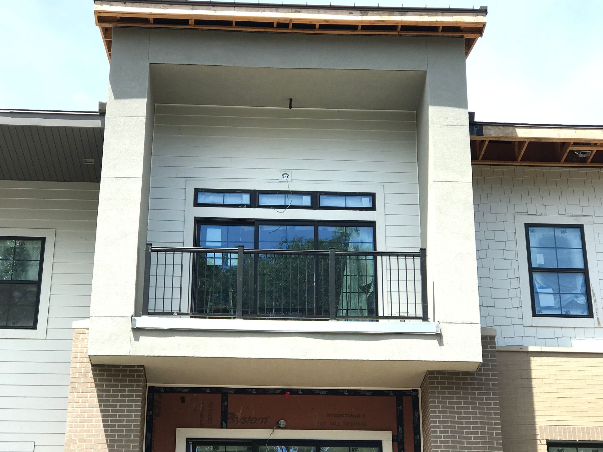 A building under construction with a balcony and windows
