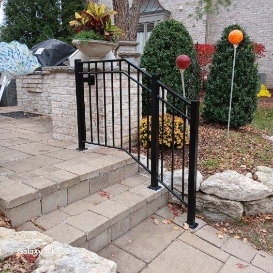 A black metal railing surrounds a set of stairs