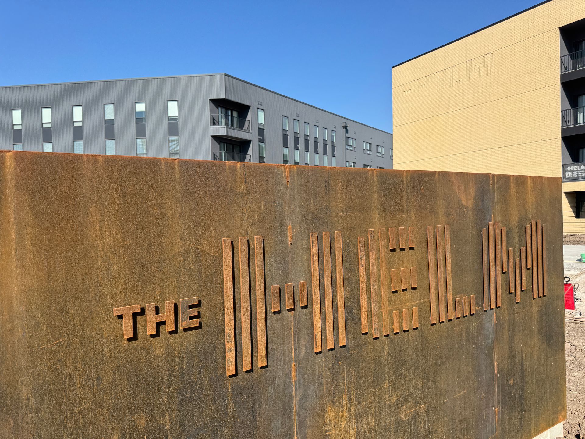 A rusty metal wall with the word HELM on it