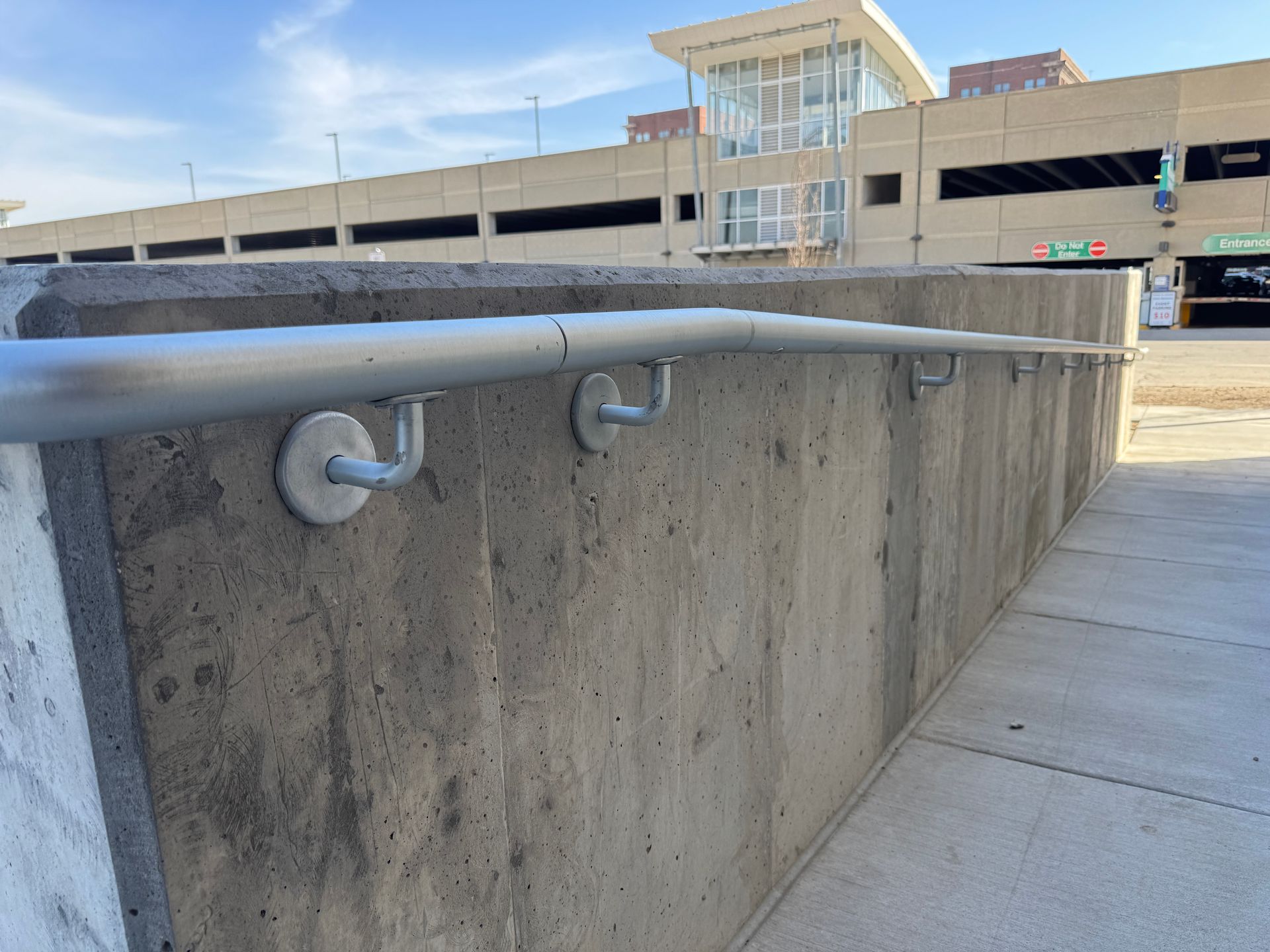 A concrete wall with a metal railing attached to it
