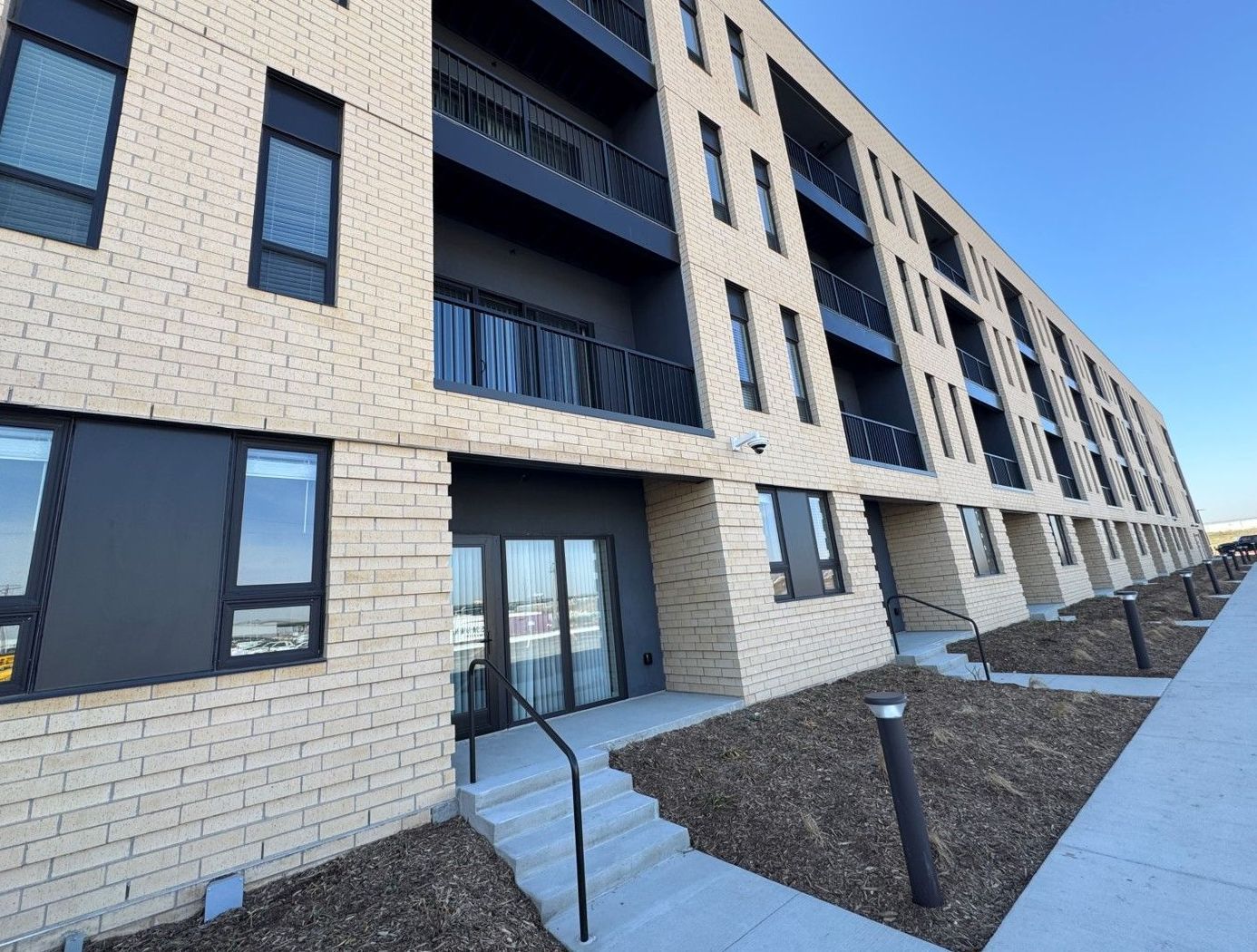 A large brick building with a lot of windows and balconies