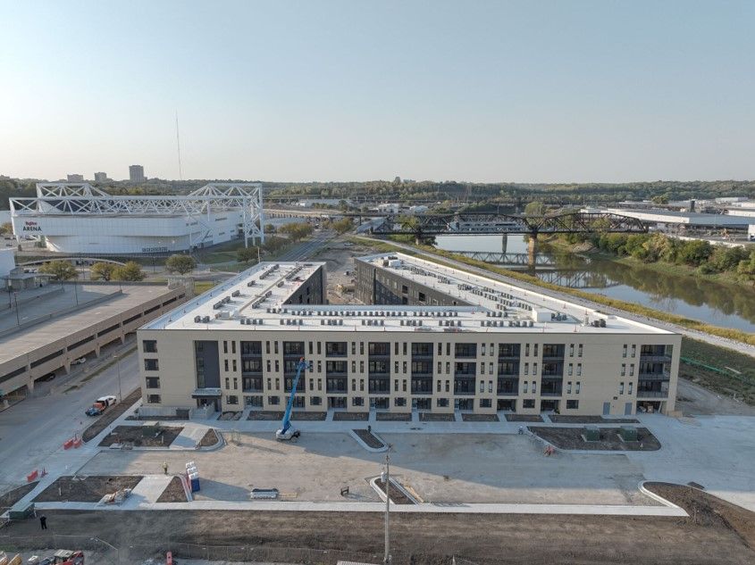 An aerial view of a large building under construction in a city.
