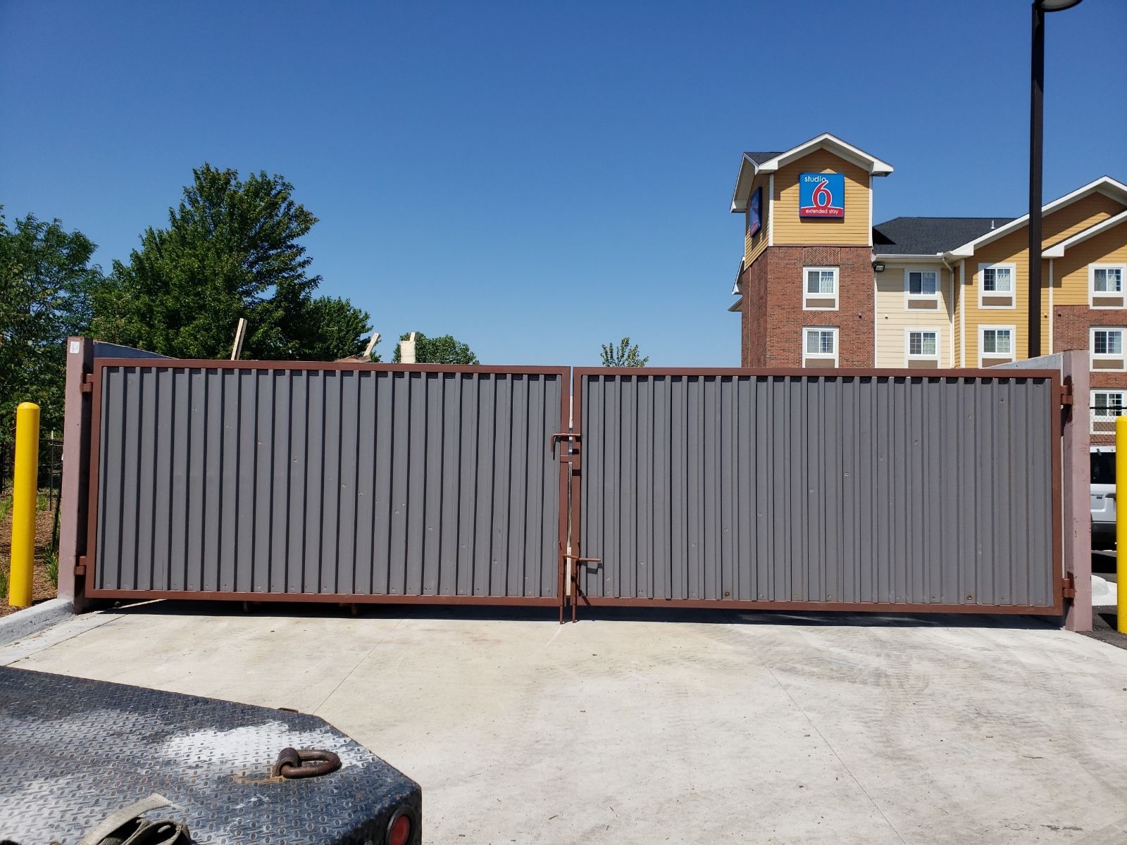 A sliding trash  gate is closed in front of a motel