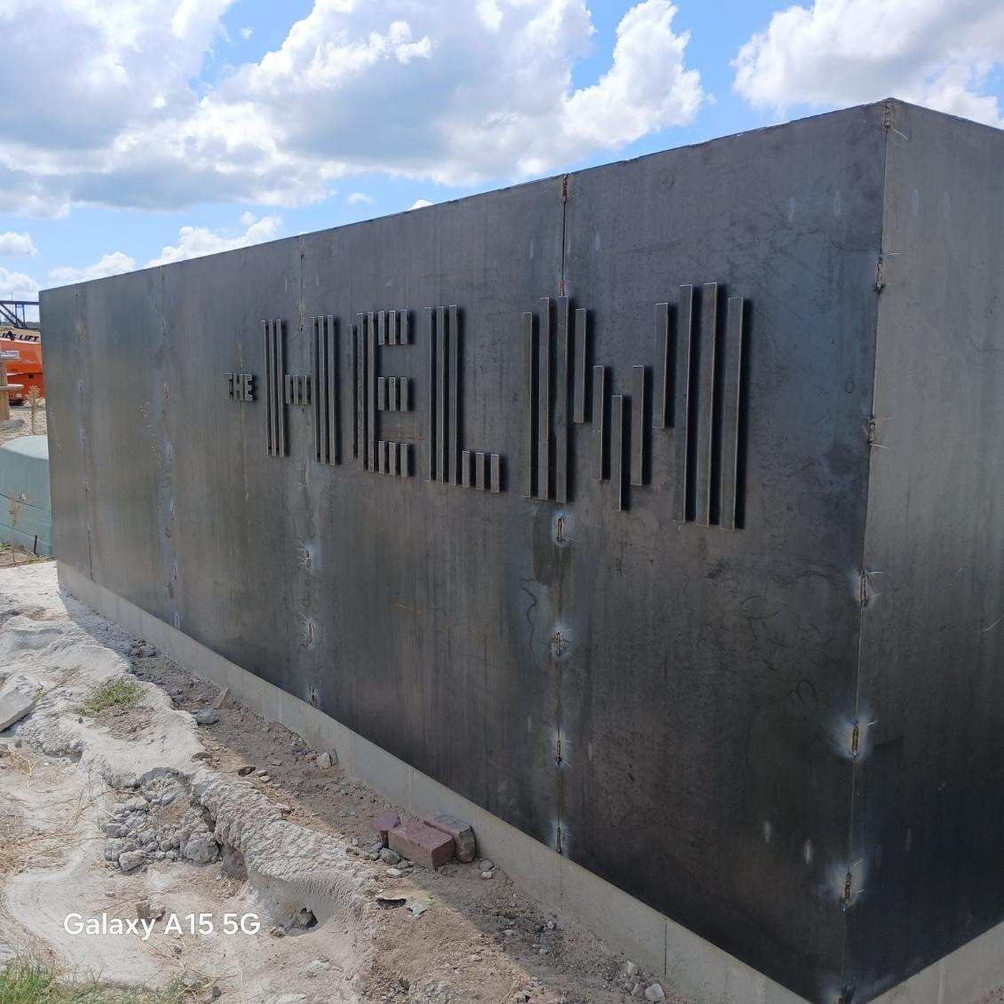 A large metal block with the word HELM written on it