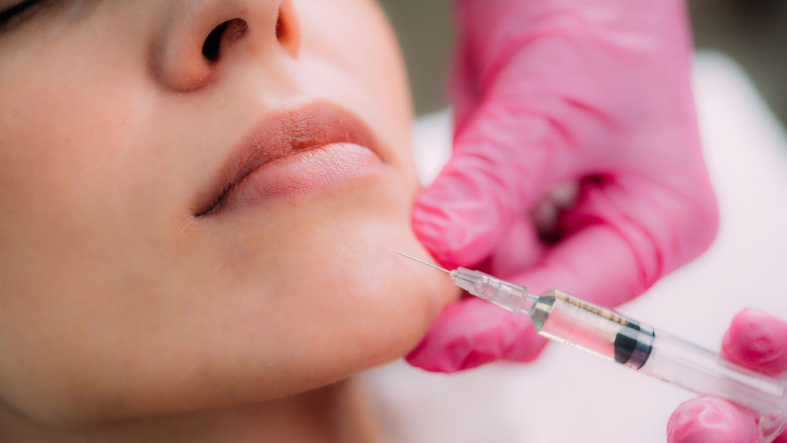 Close-up of dermal filler injection being administered by a professional.