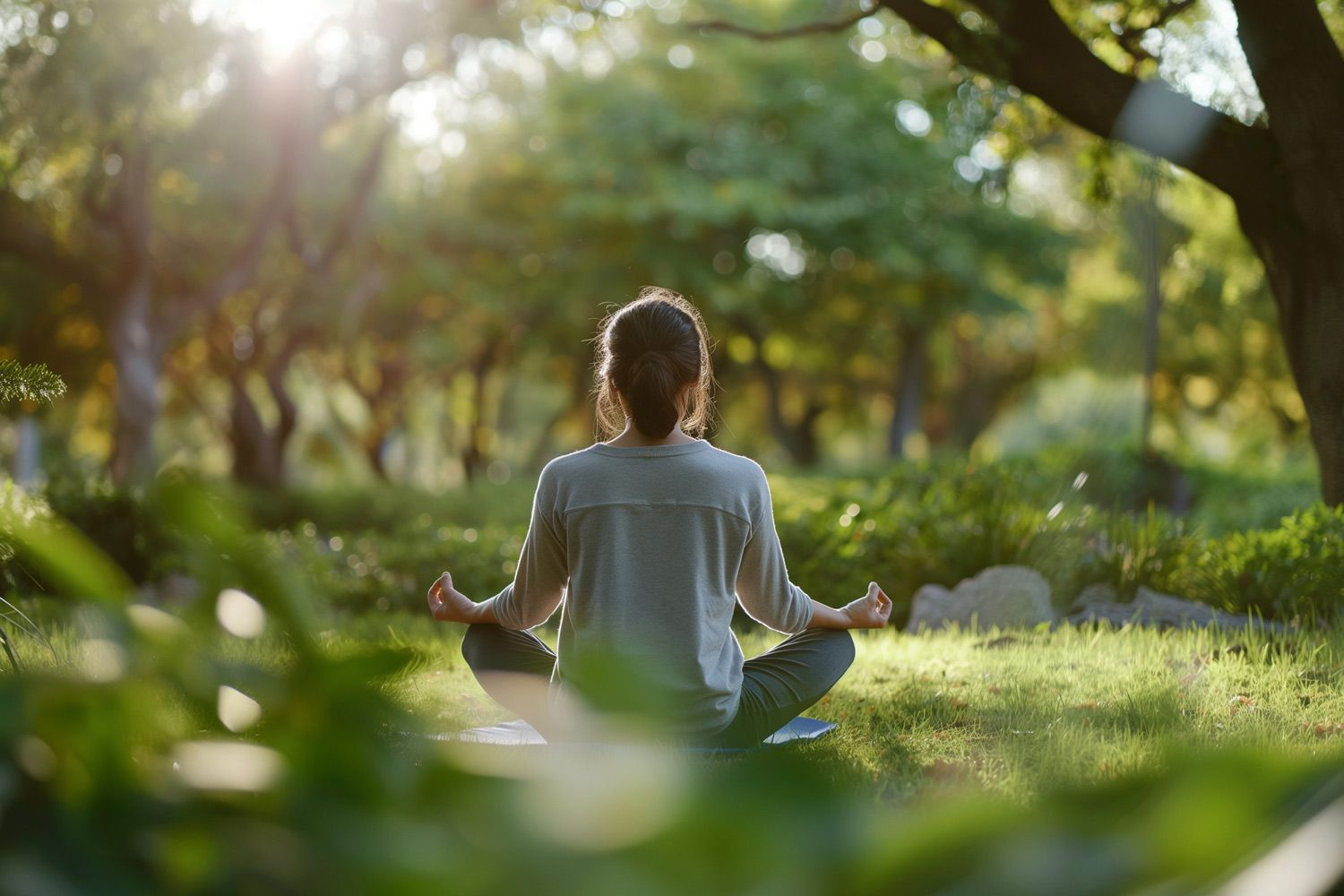 A serene setting with a person meditating outdoors, representing harmony and holistic wellness.