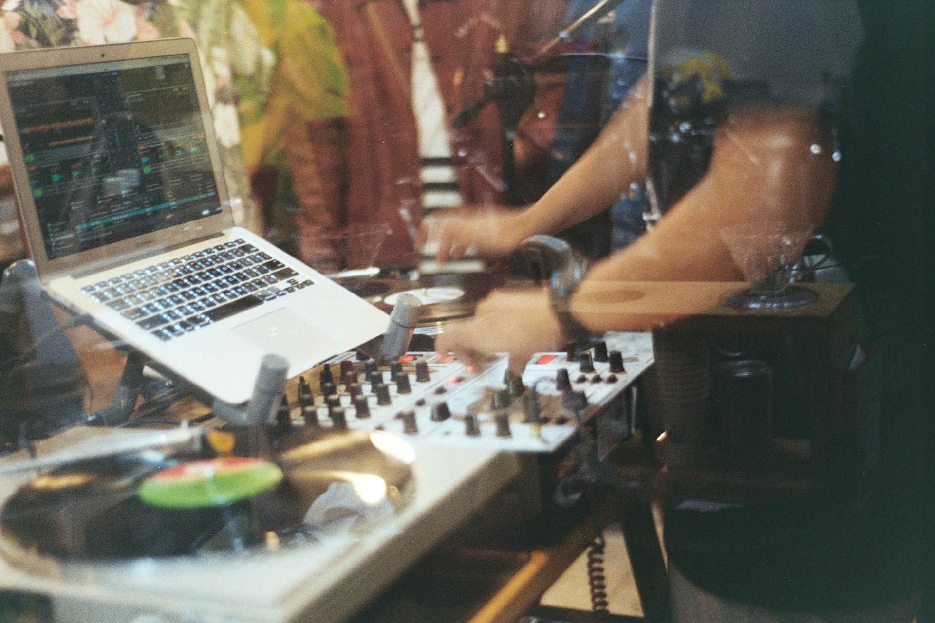 A close up of a dj playing music at a party.