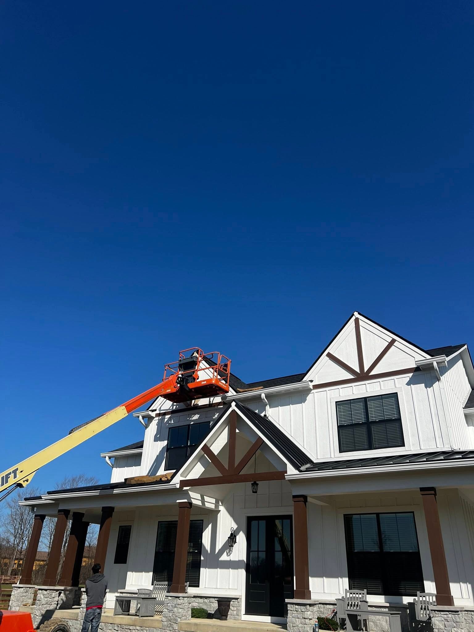 A large white house with a crane on top of it.