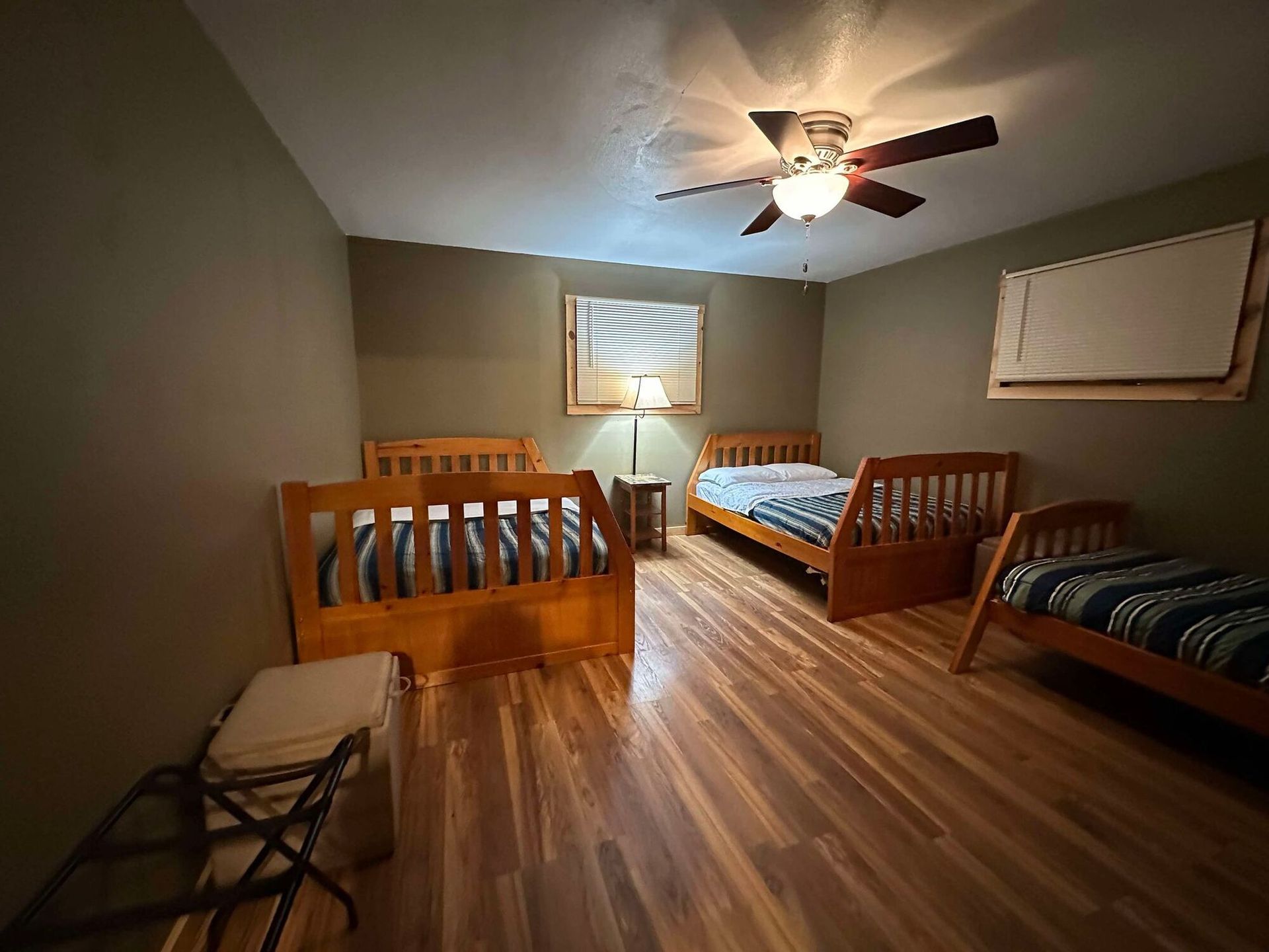 A bedroom with two beds and a ceiling fan.