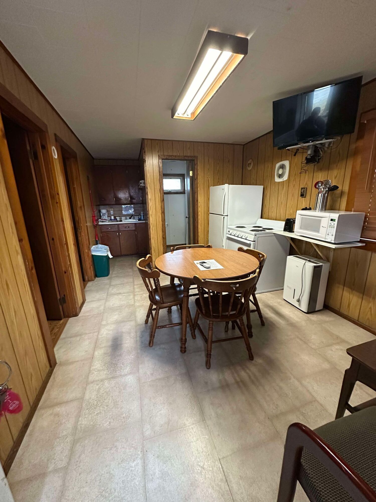 There is a table and chairs in the middle of the room.