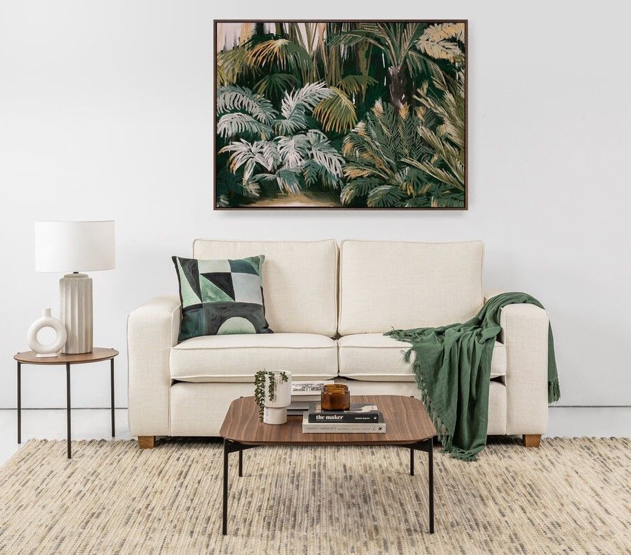 A Cozy Living Area With Frame Hanging On The Wall — Tropic Living in Clifton, QLD