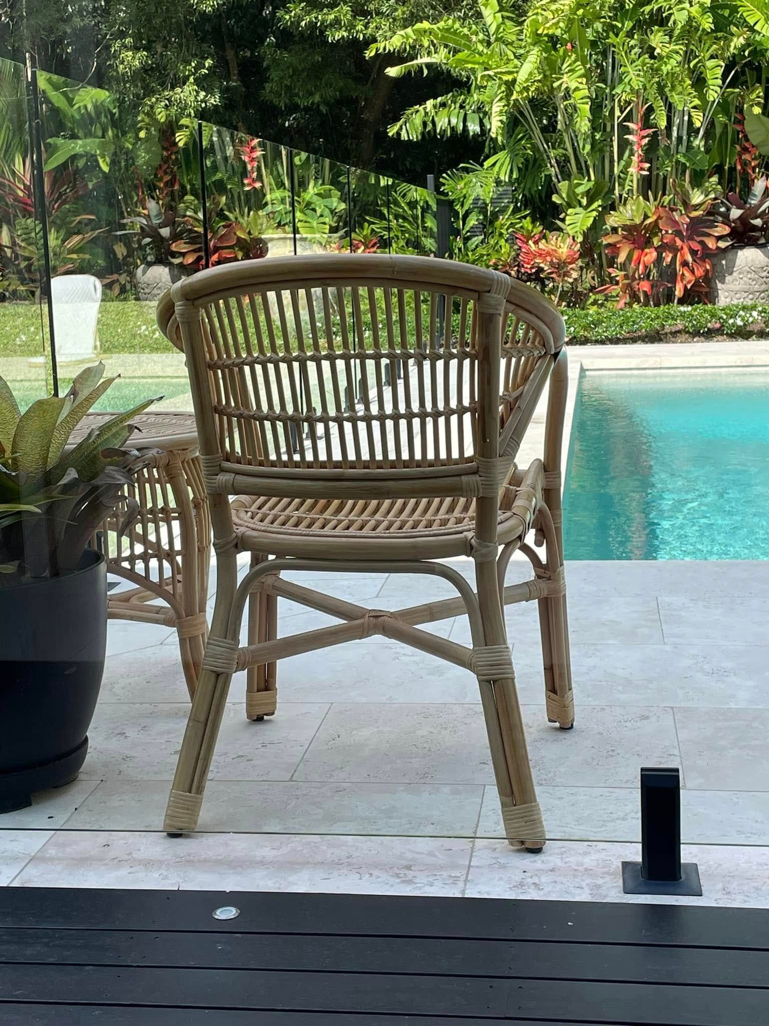 Wicker Chair by A Pool, Set on A Patio with Greenery in The Background — Tropic Living in Kewarra Beach, QLD