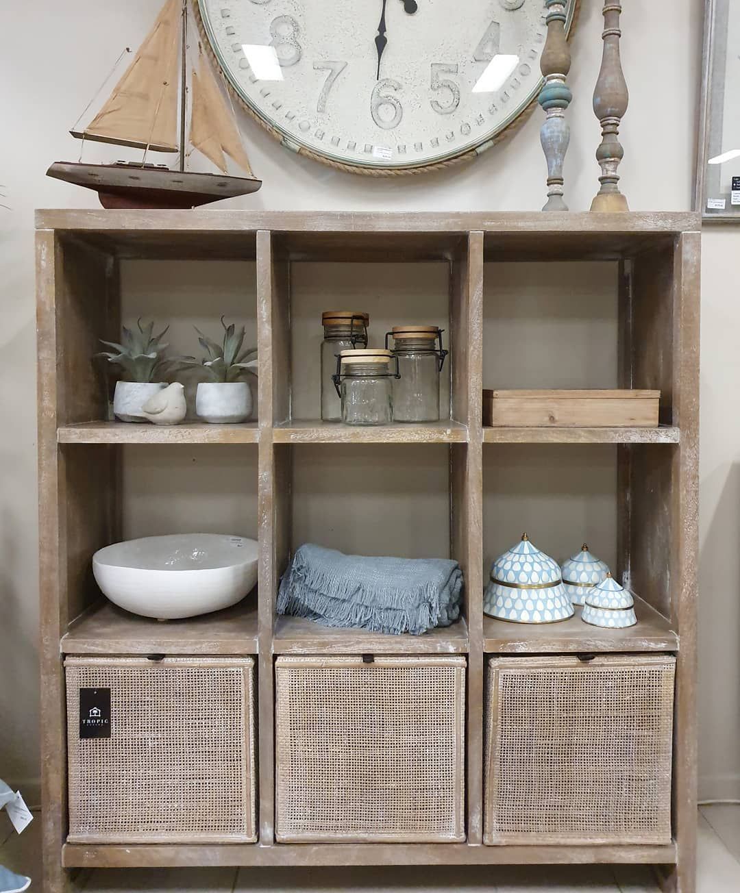 Wooden Shelf with Decor, Plants, Jars, and A Sailboat Clock on Top — Tropic Living in Port Douglas, QLD