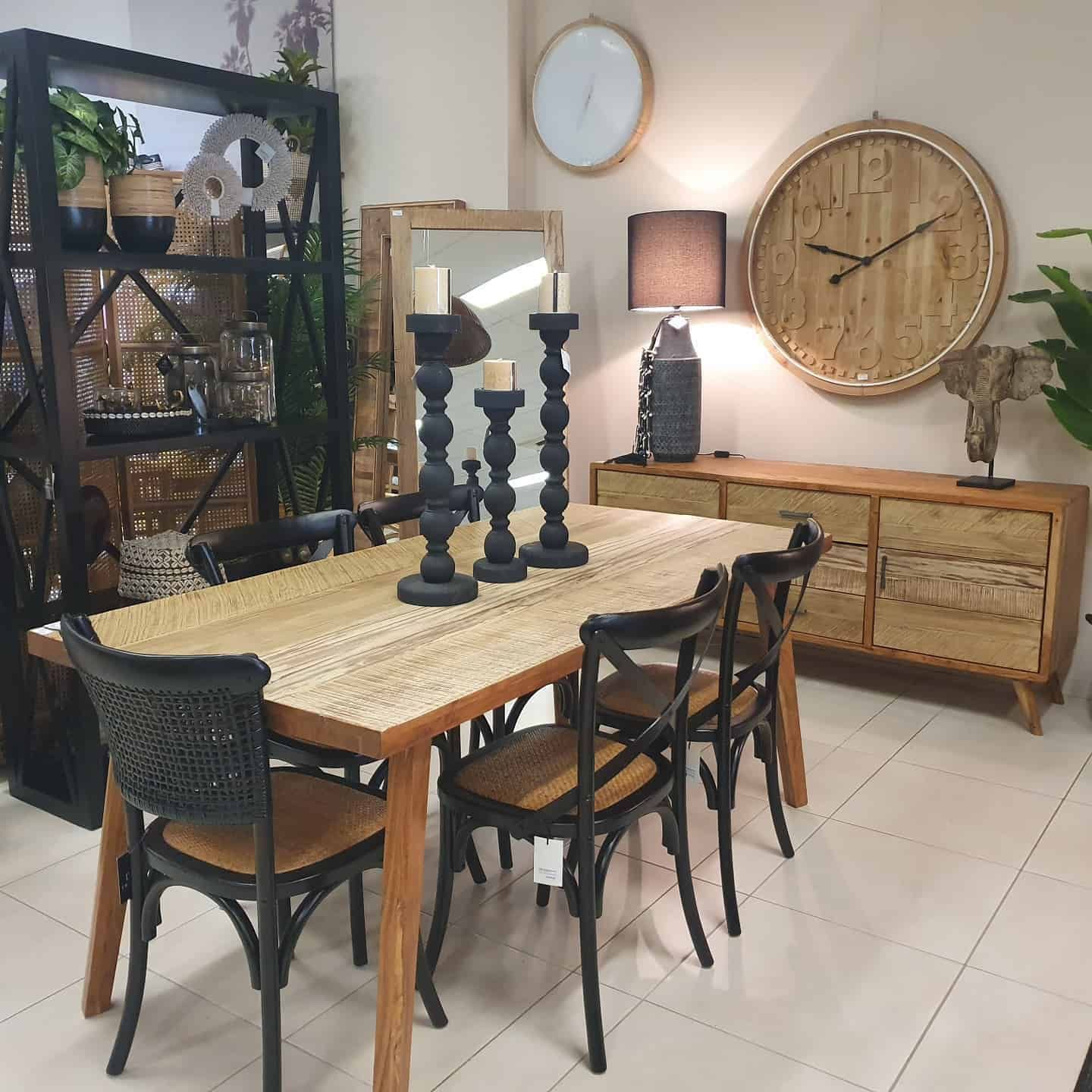 Dining Room with Wooden Table, Black Chairs, and Decorative Items — Tropic Living in Smithfield, QLD