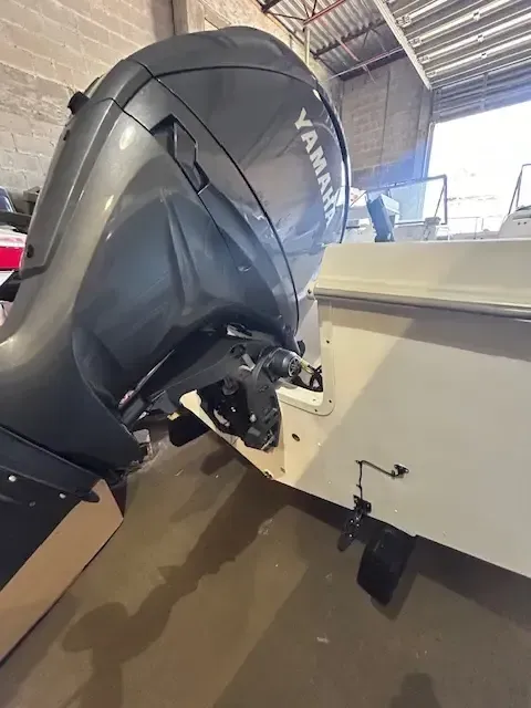 Yamaha boat motor attached to the stern of a white boat.