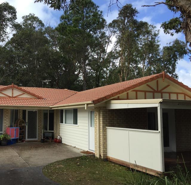 A White House With A Red Tile Roof — All Roof Restorations & Solar In Northern Rivers, NSW
