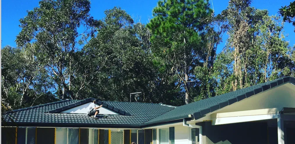 A Man Sitting on The Roof — All Roof Restorations & Solar In Northern Rivers, NSW