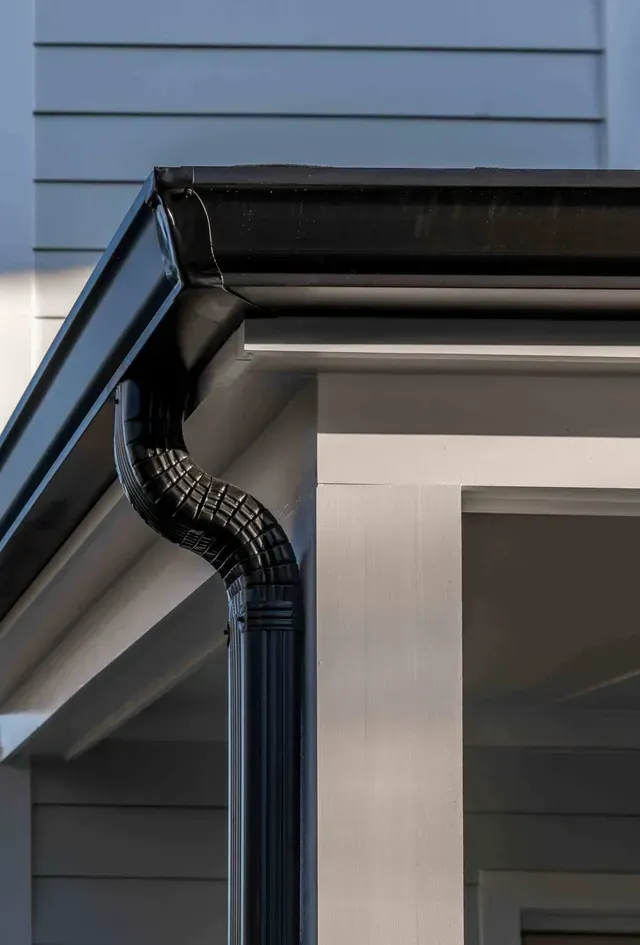 A Close Up Of A Black Gutter On The Side Of A House — All Roof Restorations & Solar In Northern Rivers, NSW
