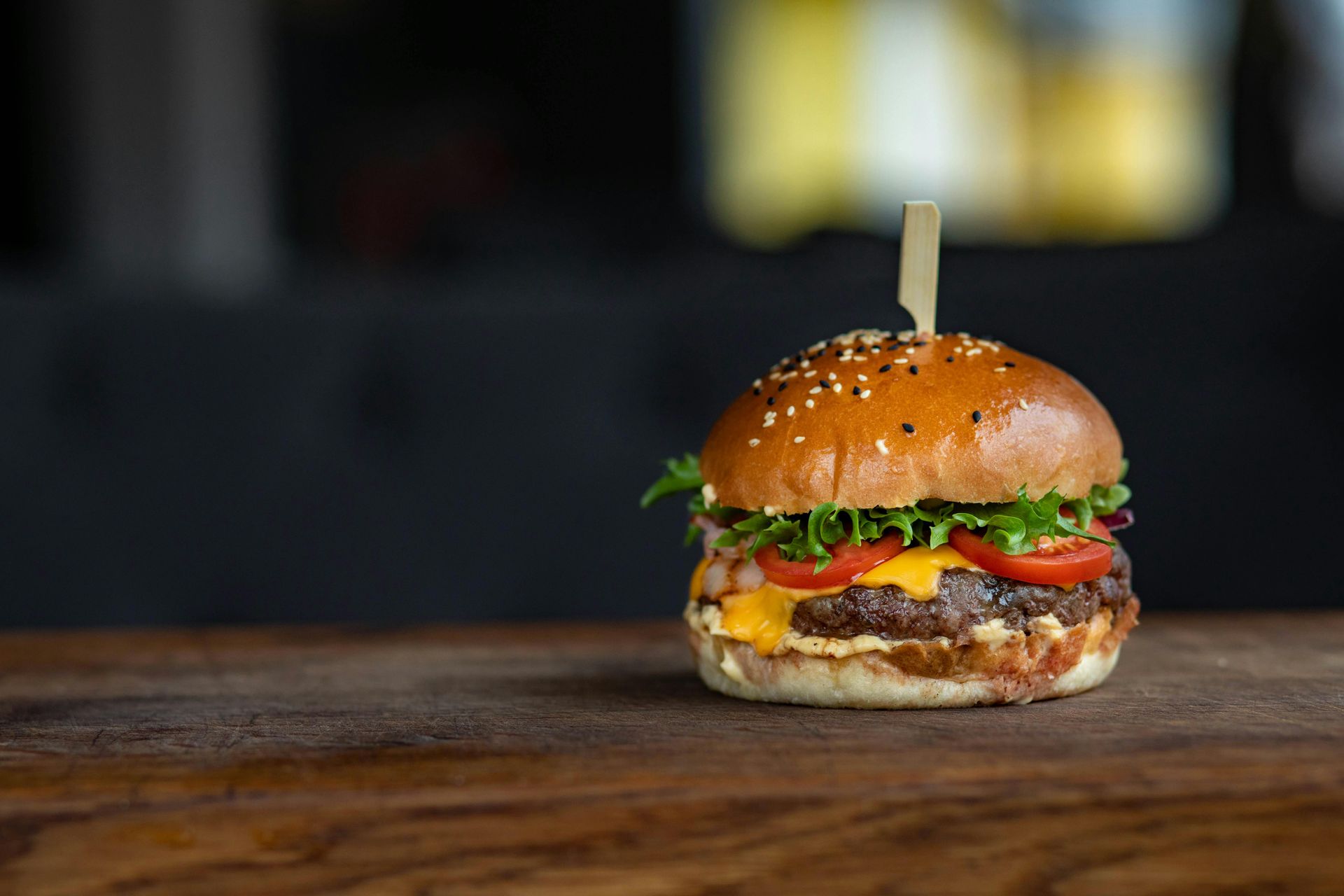 Cheeseburger on wooden board with wooden skewer in the middle of the bun - Mosaic Church, Freeport, FL
