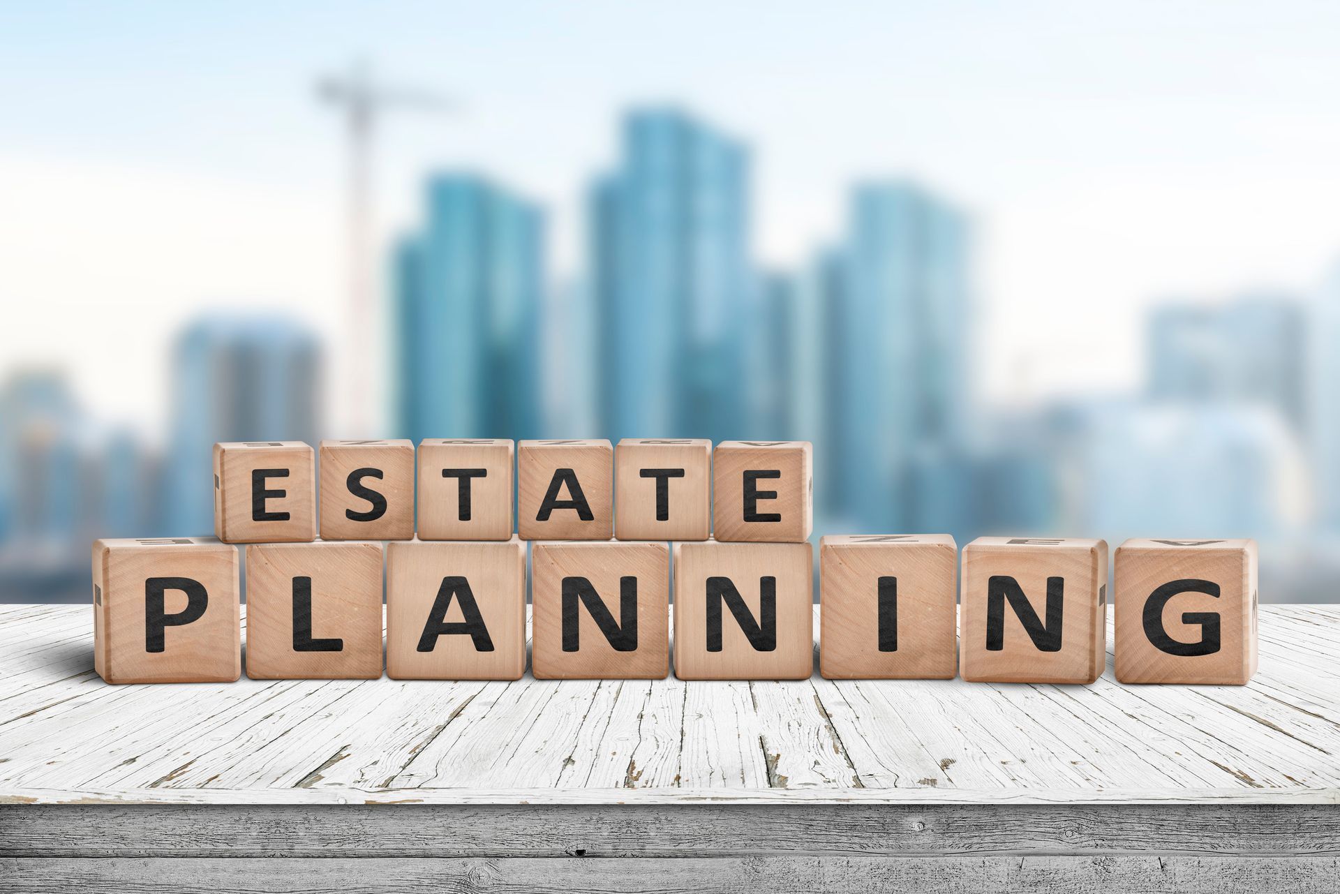 The word estate planning is written on wooden blocks on a table.