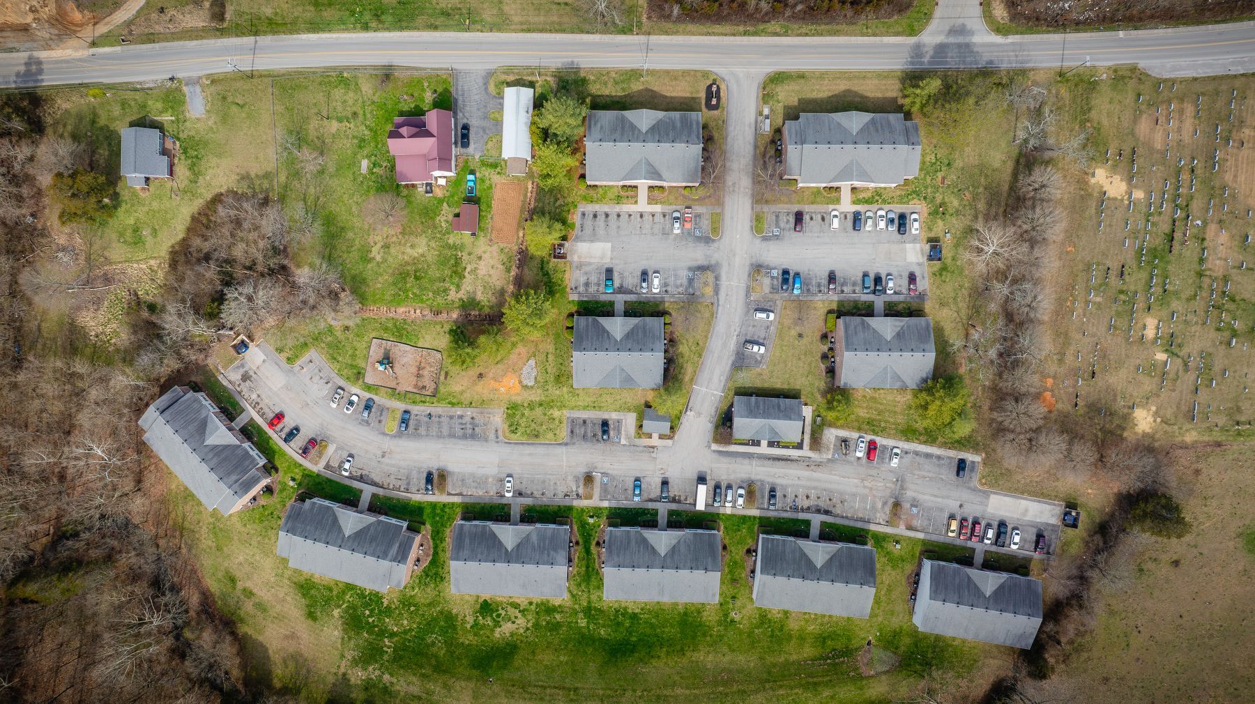 An aerial view of a residential area with lots of houses and a road.