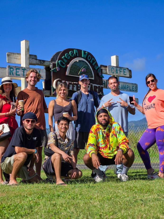 A group of people are posing for a picture in front of a sign.