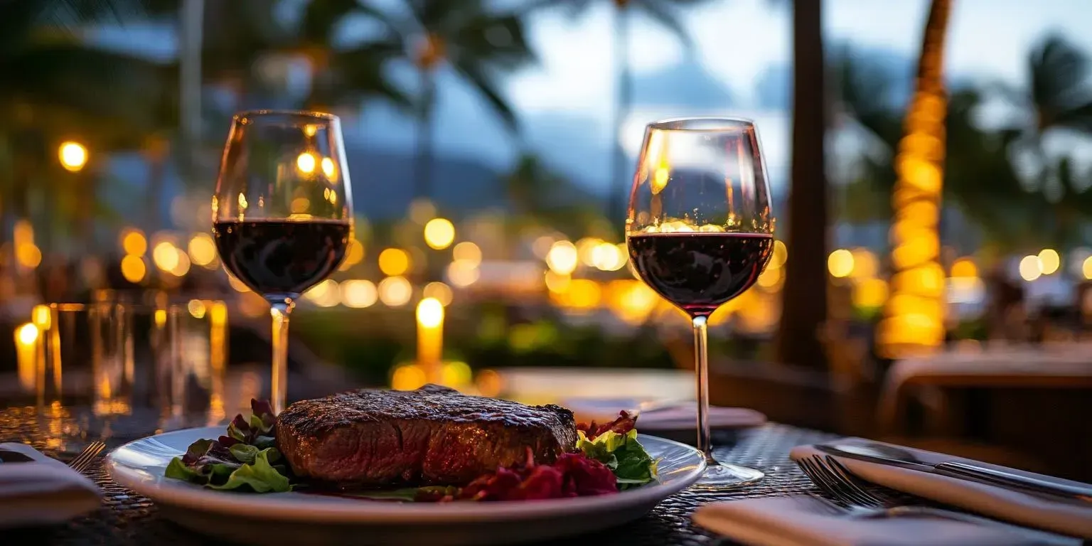 A plate of food and two glasses of wine on a table.