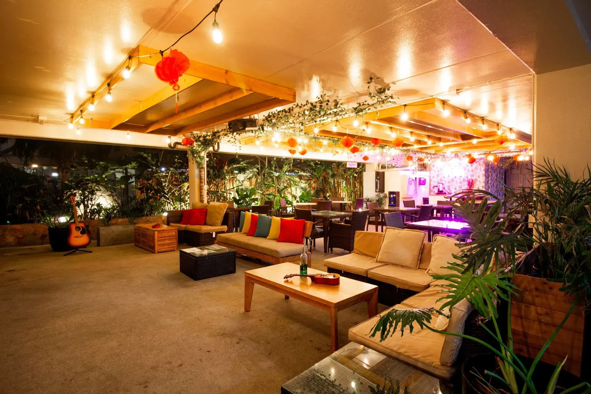 A large room with a lot of furniture and lights on the ceiling