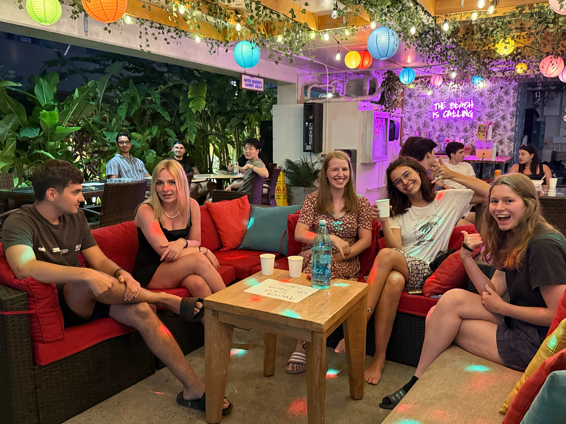 A group of people are sitting on couches in a room.