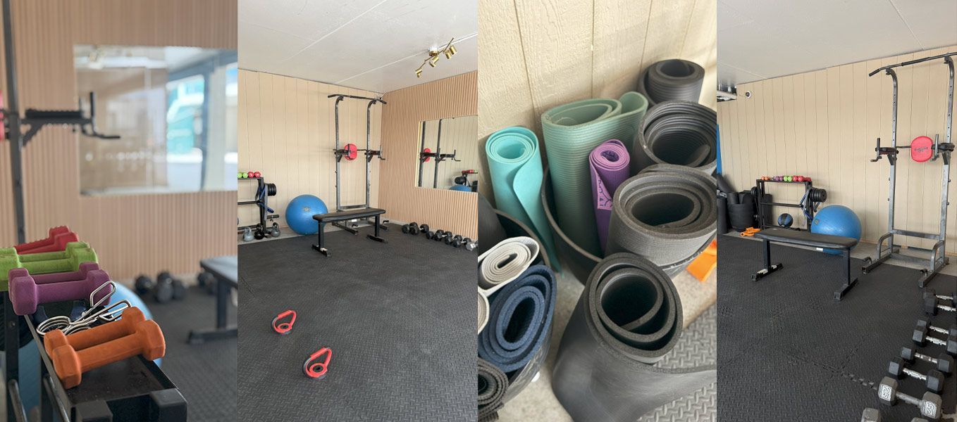 A home gym with weights, exercise mats, a balance ball, and workout equipment.