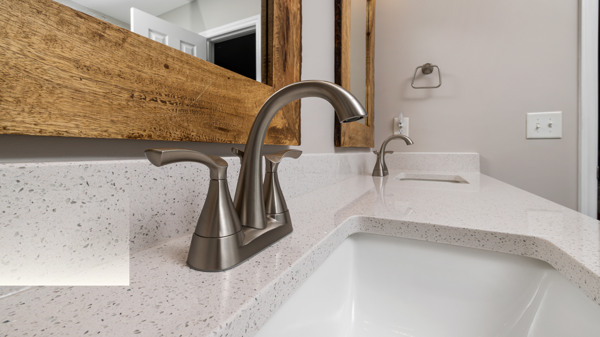 A bathroom sink with a faucet and a mirror.