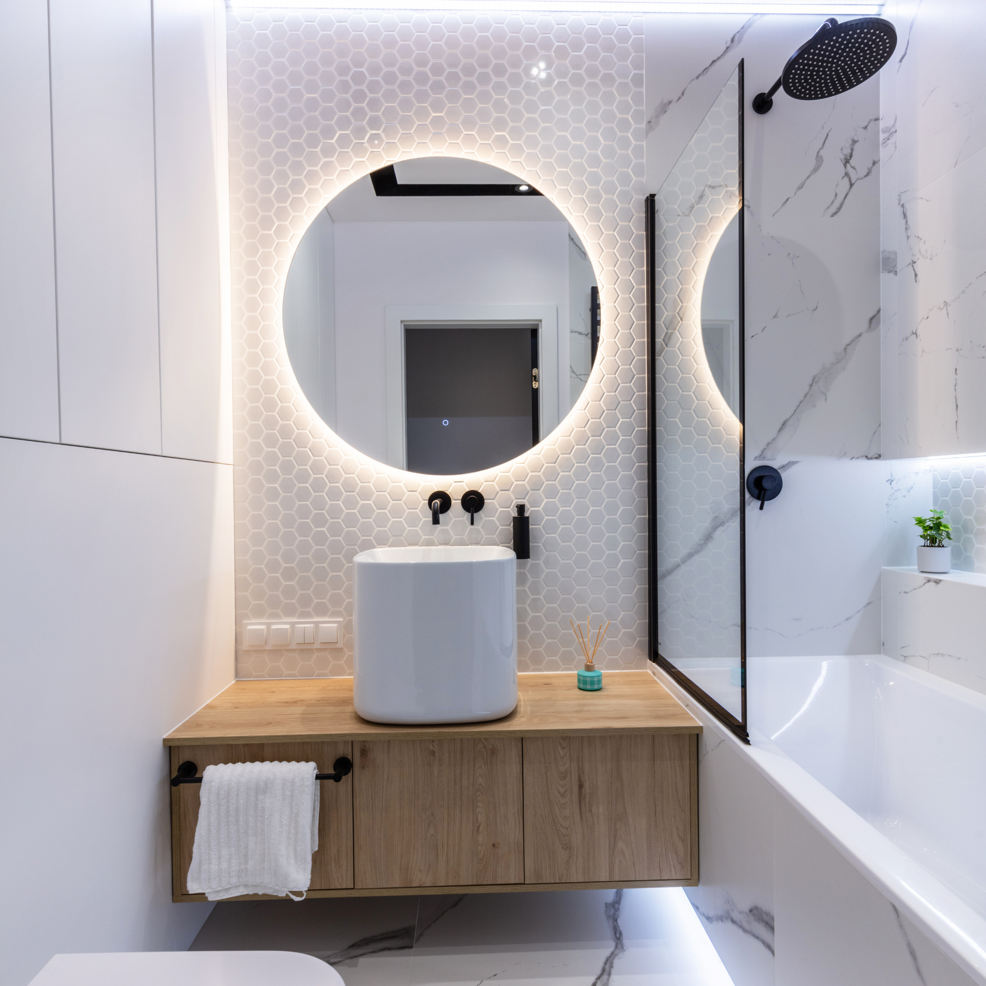 A bathroom with a sink a mirror and a bathtub