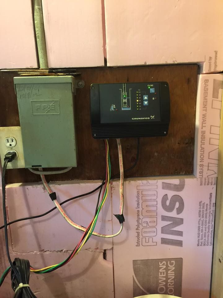 A wall with a bunch of wires coming out of it.