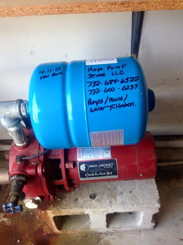 A water pump with a blue tank on top of it