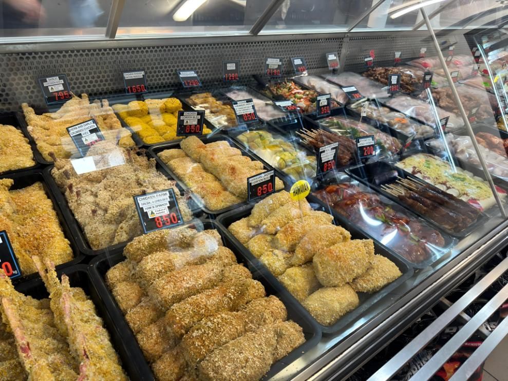 A Display Case Filled With a Variety of Food in a Grocery Store — MBW Wholesale & Bulk In Cannonvale, QLD