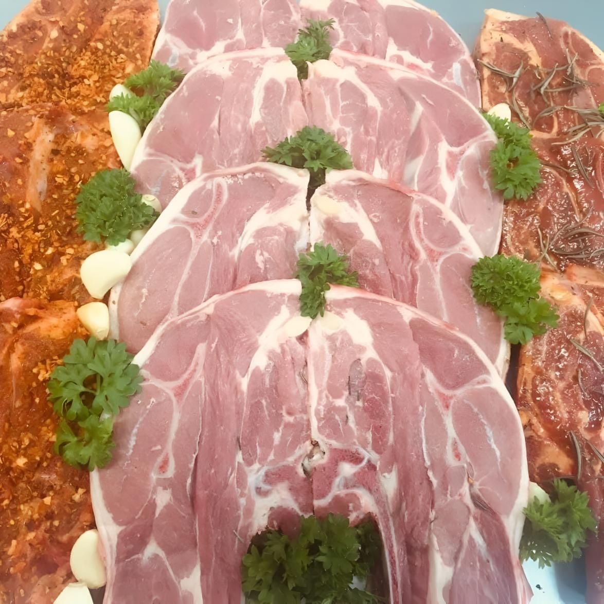 A Pile of Meat With Parsley on Top of It — MBW Wholesale & Bulk In Cannonvale, QLD