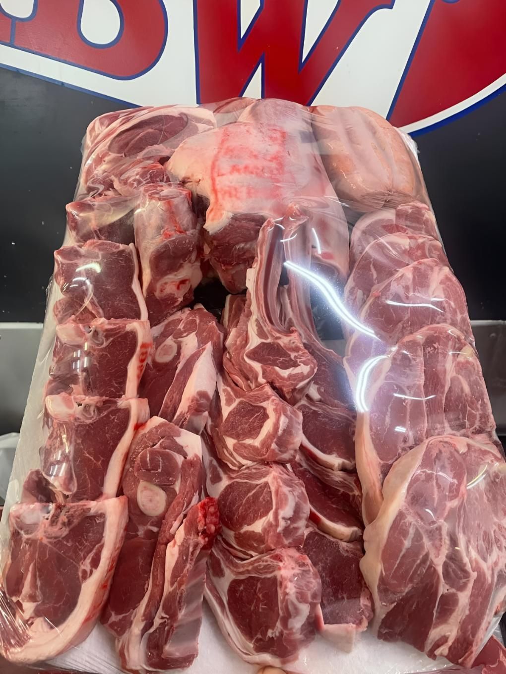 A Pile of Raw Meat is Sitting on Top of a Cutting Board — MBW Wholesale & Bulk In Cannonvale, QLD