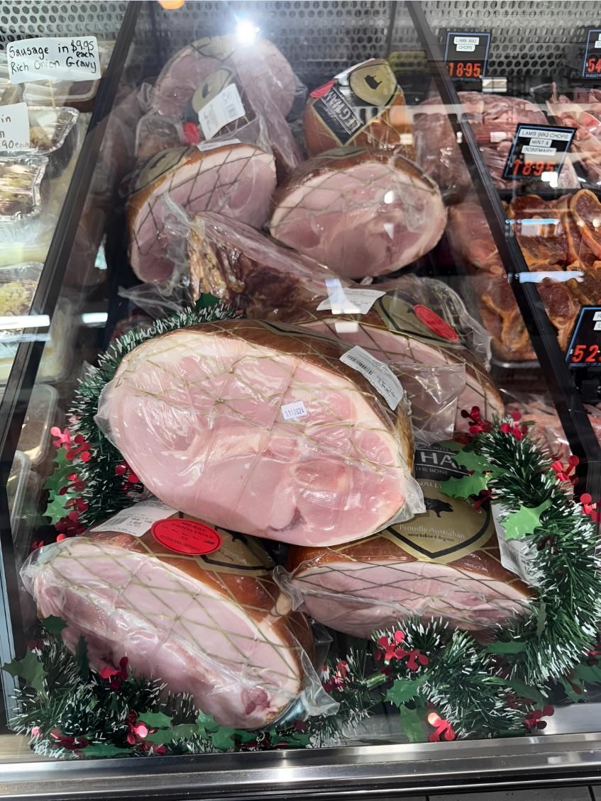 A Variety of Hams Are Displayed in a Glass Case — MBW Wholesale & Bulk In Cannonvale, QLD