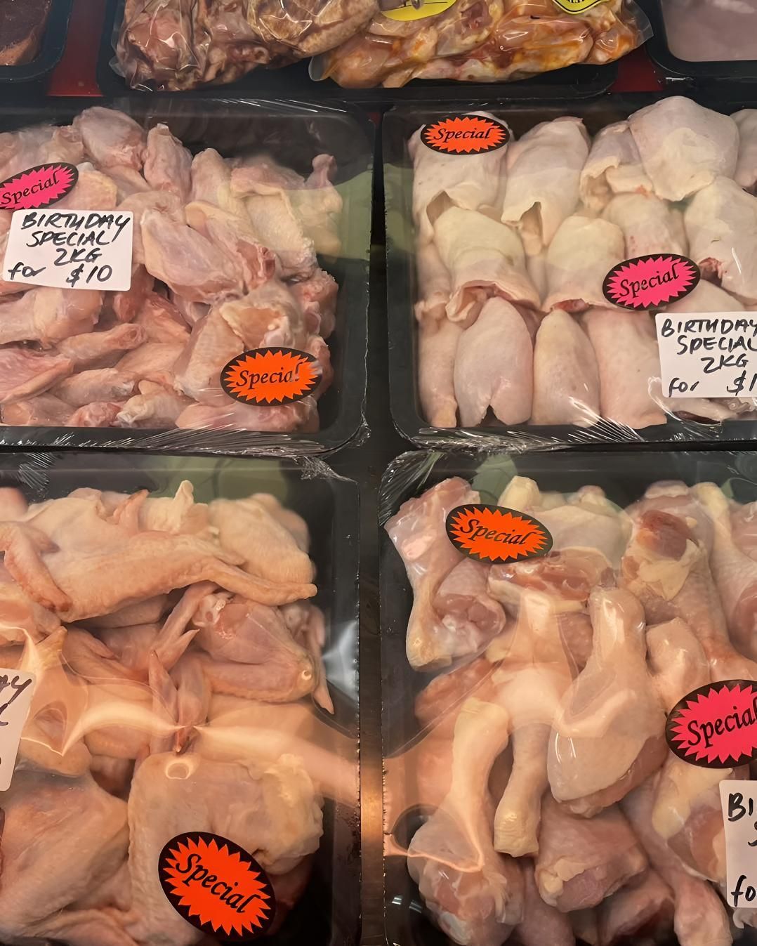 Several Trays of Chicken Are Lined Up in a Display Case — MBW Wholesale & Bulk In Cannonvale, QLD