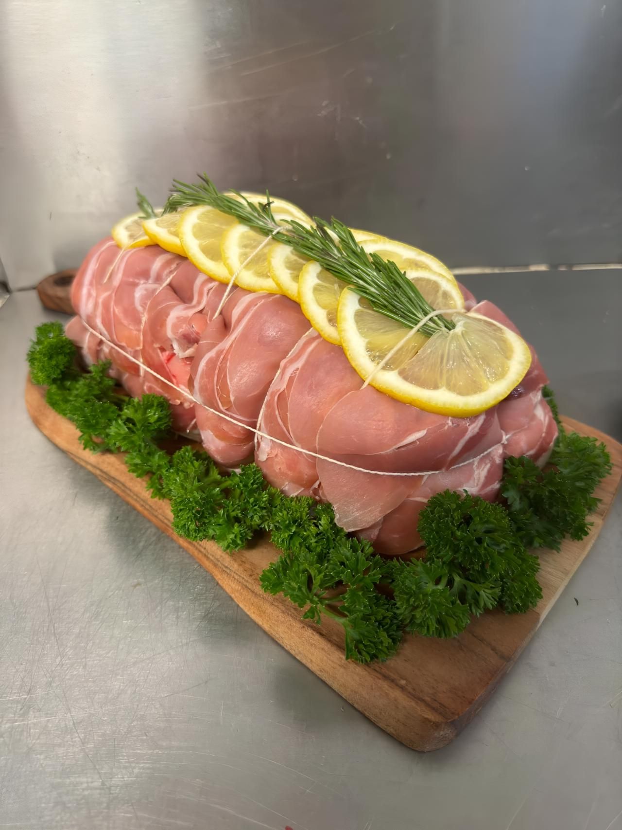 A Piece of Meat is Sitting on Top of a Wooden Cutting Board — MBW Wholesale & Bulk In Cannonvale, QLD