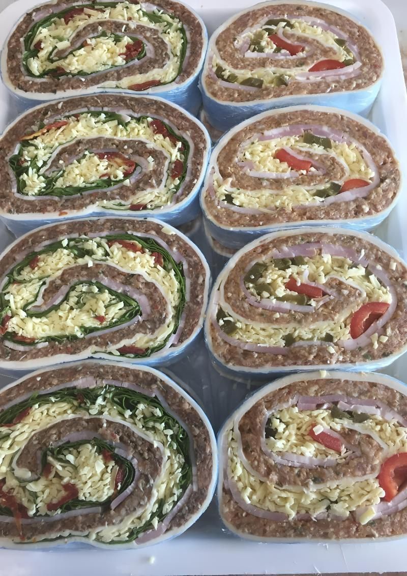 A Tray of Food With Rolls of Meat and Vegetables on It — MBW Wholesale & Bulk In Cannonvale, QLD