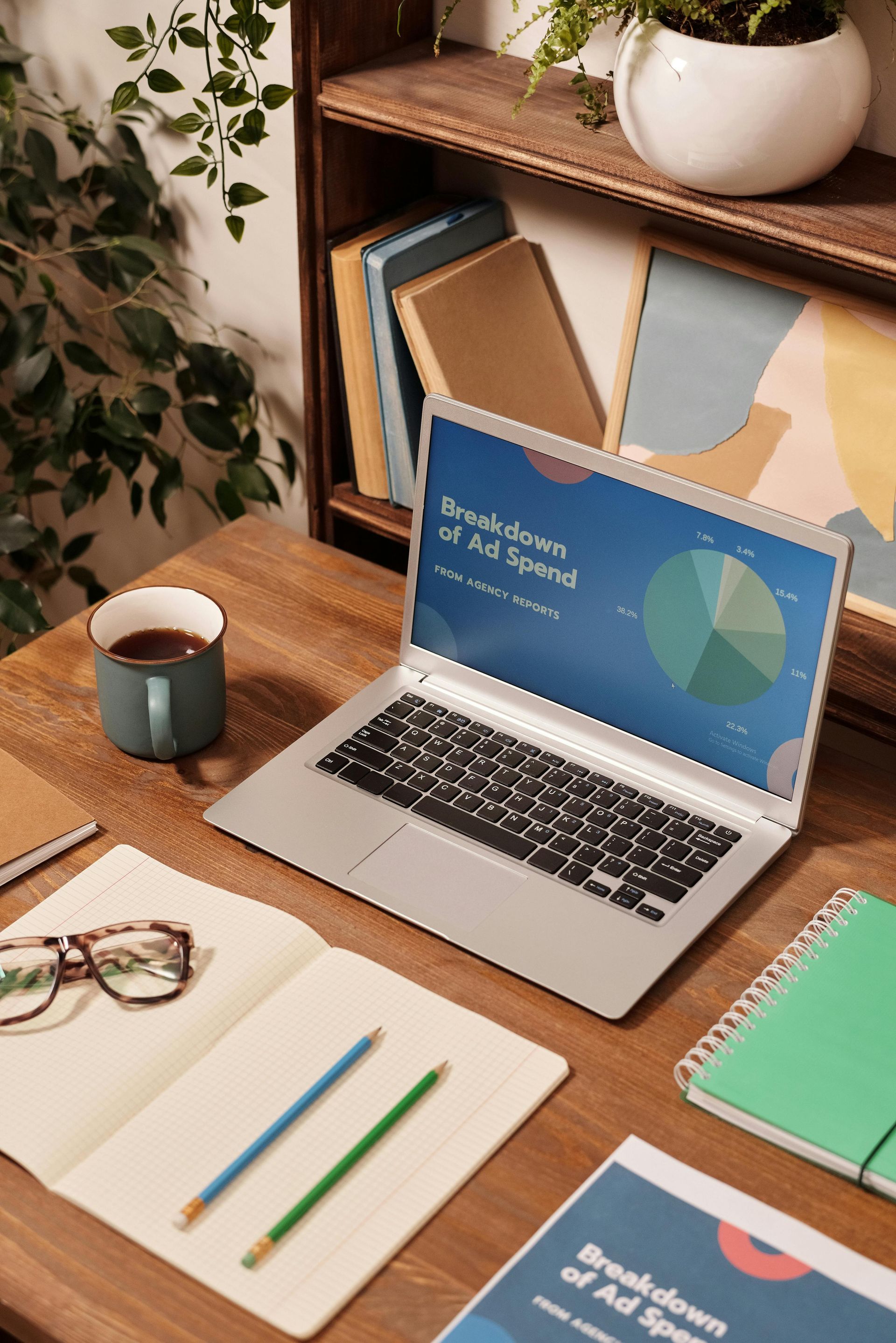 laptop computer with pie chart showing ad spend